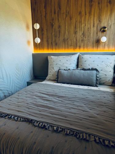 a bedroom with a large bed with a wooden headboard at Rabczański Taras z jacuzzi i otwieranym dachem in Rabka-Zdrój
