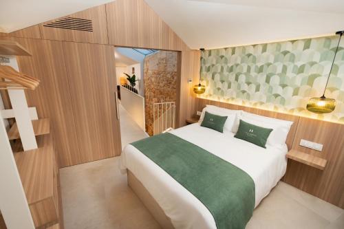 a bedroom with a large white bed with green sheets at Casa Carmela Baiona in Baiona