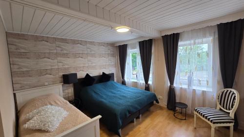 a bedroom with a blue bed and a window at Geluk in Bettingen in Bettingen