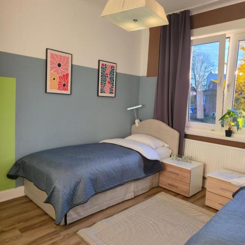 Postel nebo postele na pokoji v ubytování Gästehaus Bergedorf 2