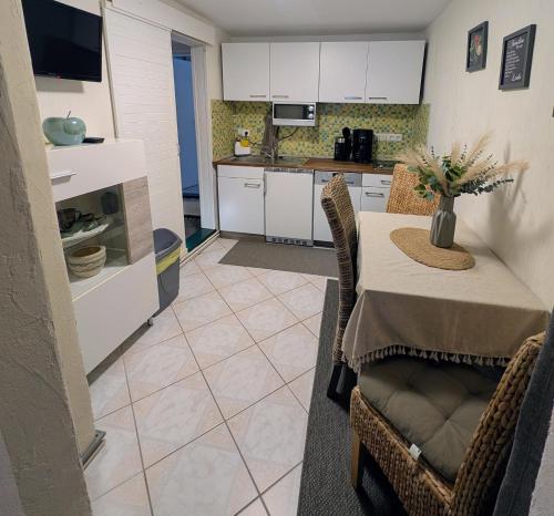 a kitchen and dining room with a table and chairs at Töpferhäuschen Tangermünde in Tangermünde