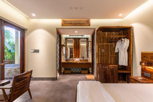 a bathroom with a sink and a mirror at Sun Village Beach Resort in Tuy Hoa