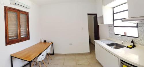 a kitchen with a sink and a wooden counter top at Hospedaje Aguilares in Aguilares