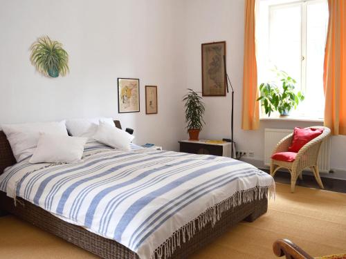 a bedroom with a bed and a red chair at Epic Location in Düsseldorf