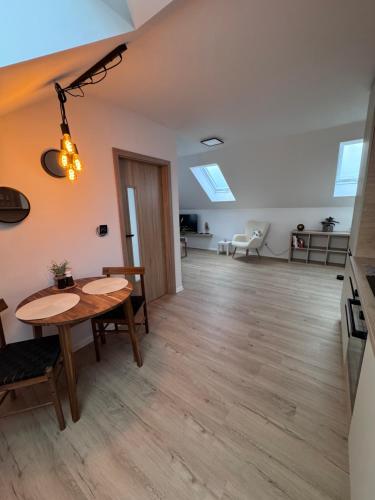 a living room with a table and a dining room at Apartmán Veronika in Humpolec