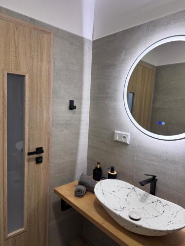 a bathroom with a sink and a mirror at Apartmán Veronika in Humpolec