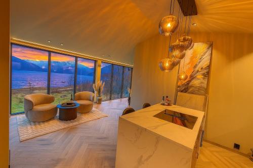a living room with a view of the ocean at Aurora Suite in Tromsø