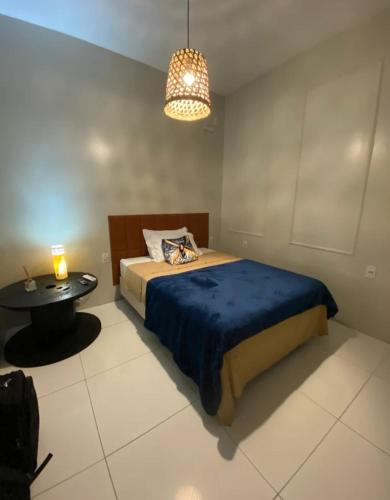 une chambre avec un lit et une table dedans dans l'établissement Vida & Brisa, à Pelotas