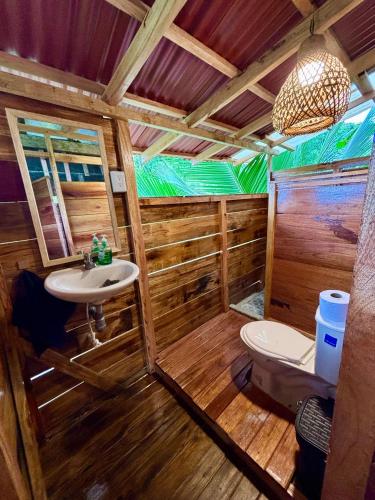 a bathroom with a toilet and a sink at La Roca House in El Valle