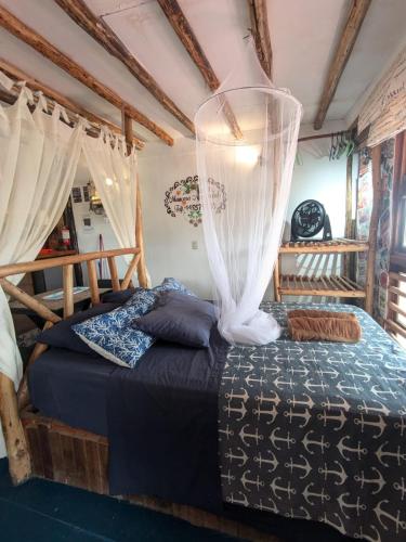 a bedroom with a bed with a canopy at cozy studio in Máncora