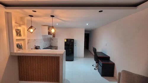 a kitchen with a black refrigerator and a counter at Apartaestudio PA-TY in Cali
