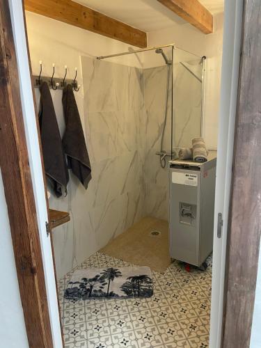 a bathroom with a shower and a washer at Casita Ricarda in Tazacorte