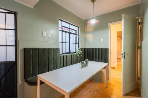 a white table in a room with green walls at Casa 906 in Puebla