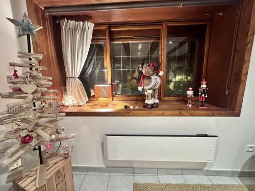 a window with christmas decorations in a room at Ide'Alsace in Eguisheim