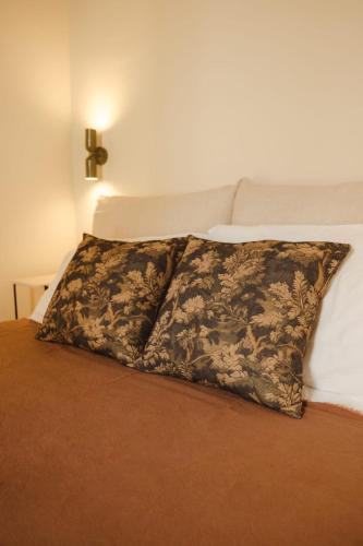 a pillow sitting on top of a bed at Traditional Maltese home in the three cities - 500m away from Valletta Ferry in Cospicua