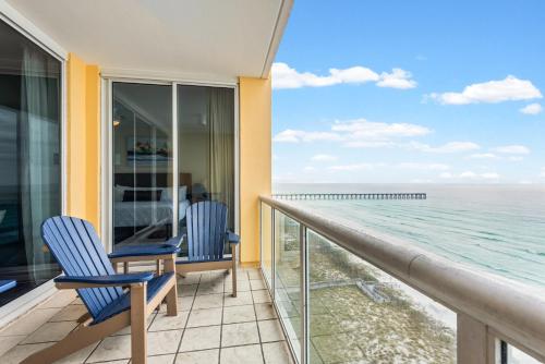 a balcony with chairs and a view of the ocean at Modern Gulf Front Condo, Pool, 2 Hot Tubs, Platinum Beach Service, Endless Views in Navarre