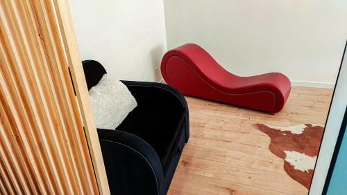 une paire de chaussures rouges posées à côté d'un canapé dans l'établissement Апартаменти на Лисенка, à Dorotichi