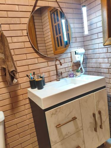 a bathroom with a sink and a mirror at Cabana liberdade 2 in Rio dos Cedros