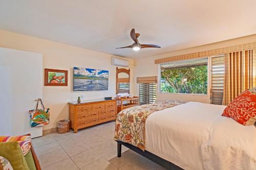a bedroom with a bed and a ceiling fan at Kahana Sunset B4B in Lahaina