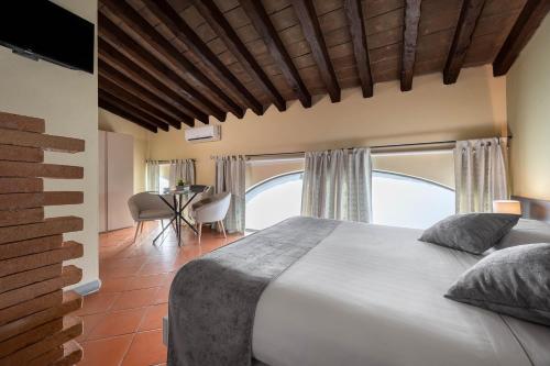 a bedroom with a large bed and a table at Villa D&D in Parma