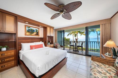 a bedroom with a bed and a ceiling fan at Lahaina Shores 229 in Lahaina