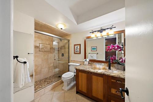 a bathroom with a toilet and a shower and a sink at Lahaina Shores 229 in Lahaina