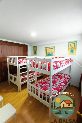 a room with three bunk beds in a room at La Balsa in Matalebreras