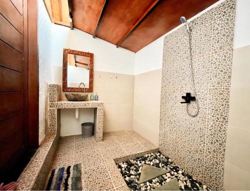 a bathroom with a shower and a sink at UTOPIA in Gili Air