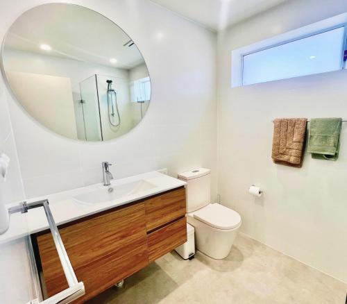 a bathroom with a sink and a mirror at Prickly Pear Stays in Merewether - Ranclaud St in Merewether
