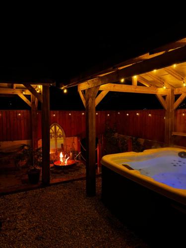a jacuzzi tub in a backyard at night at Hot tub Retreat In The Valley's Of South Wales in Abertillery