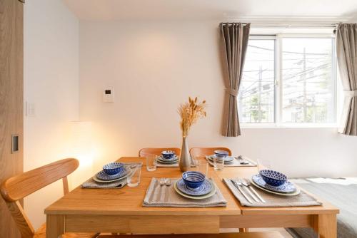 a dining room table with blue and white dishes on it at M3Corner1 1-3F Detached house M3C1 in Musashino