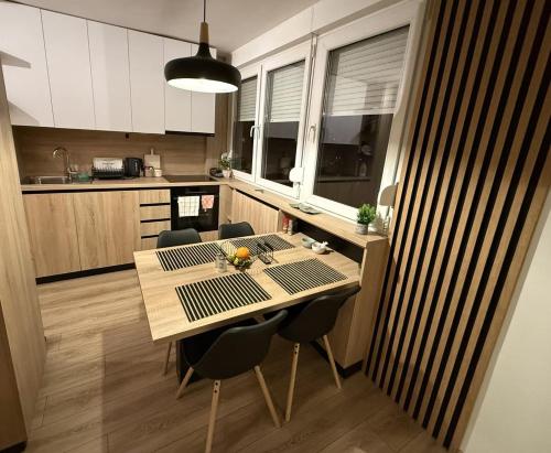 a kitchen with a table and chairs in a kitchen at Central Spot BL in Banja Luka