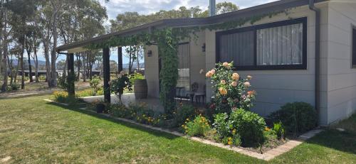 a house with a pergola with a bench in a yard at Hideaway In Hartley in Hartley