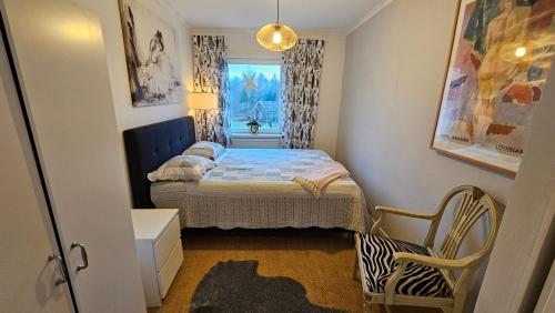 a small bedroom with a bed and a window at Little Cabin in Gnosjö