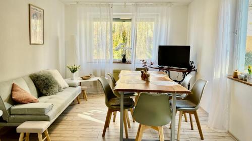 a living room with a table and a couch at Apartment AlbGlück 2 Hechingen, 3 Schlafzimmer, 1-7 Personen, Burg 5 km in Hechingen