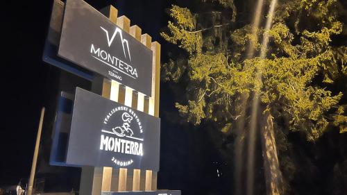 a couple of signs on a pole with trees at Snowfall Luxury Suites Jahorina in Jahorina