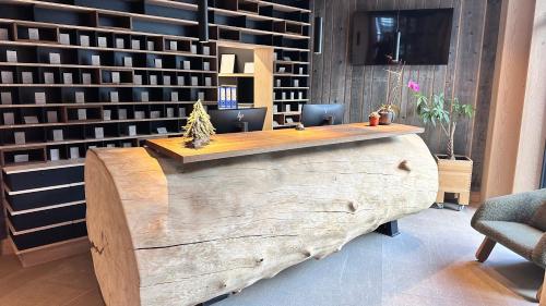 a large wooden desk in a room with chairs at Snowfall Luxury Suites Jahorina in Jahorina