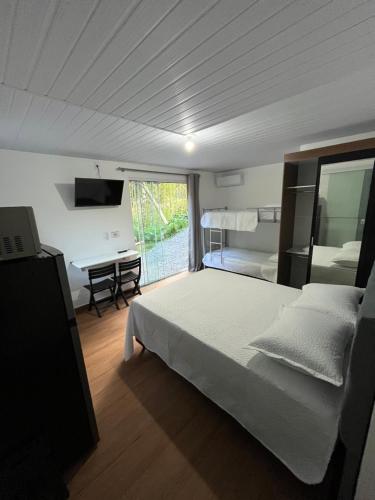 Ένα ή περισσότερα κρεβάτια σε δωμάτιο στο Flat privativo Residencial Schlichting