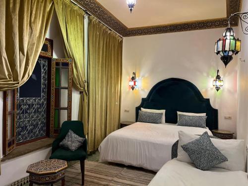 Postel nebo postele na pokoji v ubytování Riad Dar Mama Laila