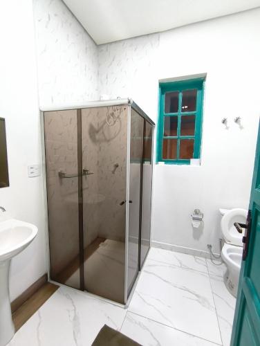 a bathroom with a shower with a sink and a toilet at Hobi Hotel Boutique - Bela Vista - Prox a Av Paulista in São Paulo