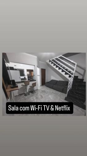 a living room with a staircase in a house at Casa de condomínio com piscina e churrasqueira in Sao Paulo