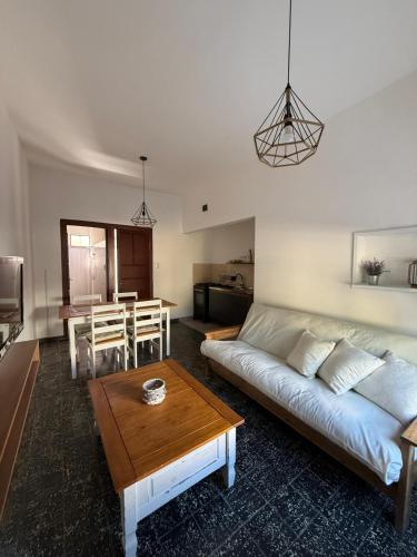 a living room with a couch and a table at Casa céntrica in Carmelo