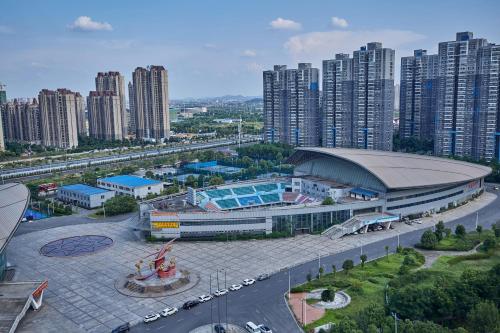 an aerial view of a stadium in a city with tall buildings at 品缦芸酒店长沙高铁南站沙湾公园地铁站店 in Changsha