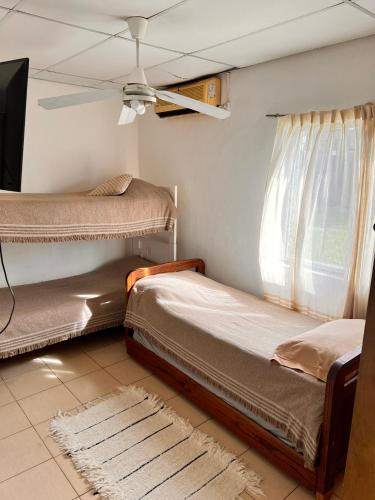 a bedroom with two bunk beds and a window at Casa de dos dormitorios en villa adela a 10 minutos del centro para 7 personas se aceptan mascotas in Concordia