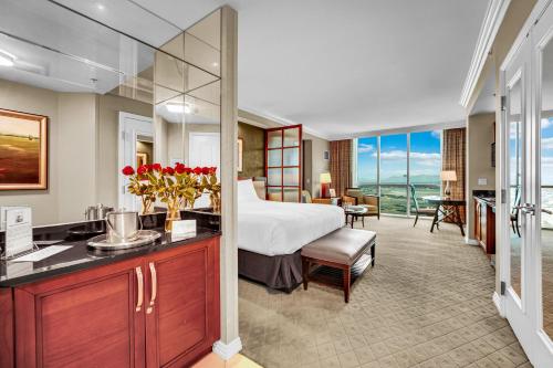 a hotel room with a bed and a bathroom at Solara Vita at MGM Signature in Las Vegas