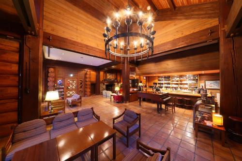 a dining room with a chandelier and a library at Hakkoda Hotel in Aomori