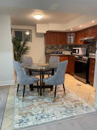 a kitchen with a dining room table and chairs at Hanan Hospitality in Toronto