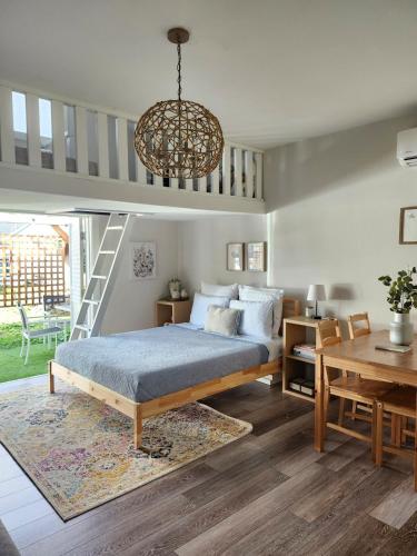 a bedroom with a bed and a chandelier at Saltline Studio in Tillamook