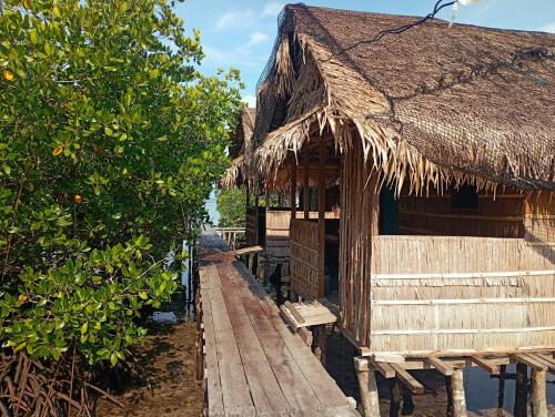 MinyaifuinにあるSeawhip Homestayの藁葺き屋根の建物