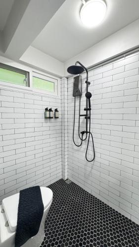 a bathroom with a toilet and a shower at Little Escape in Bangkok
